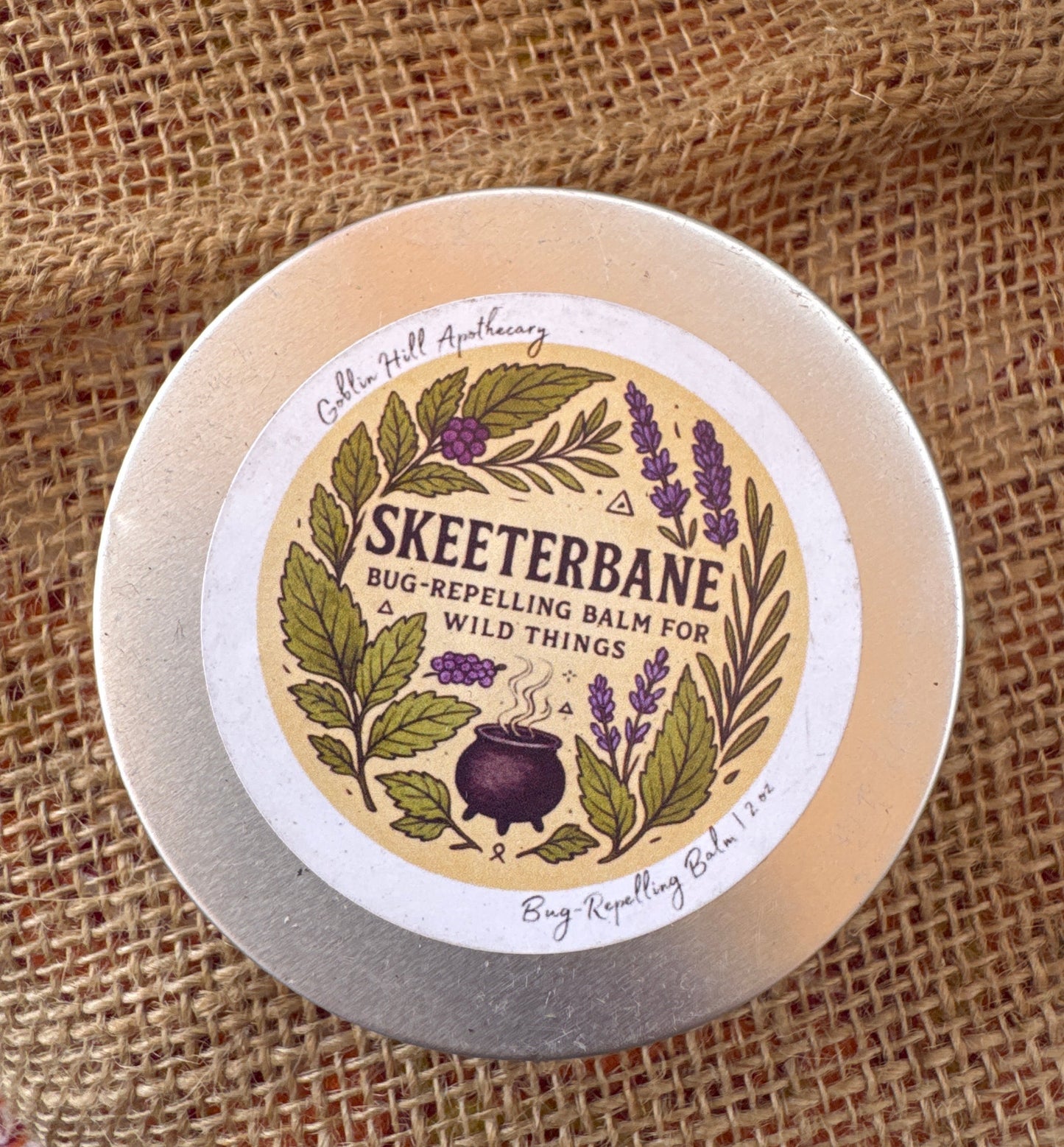 Skeeterbane bug repelling balm container on a textured fabric background