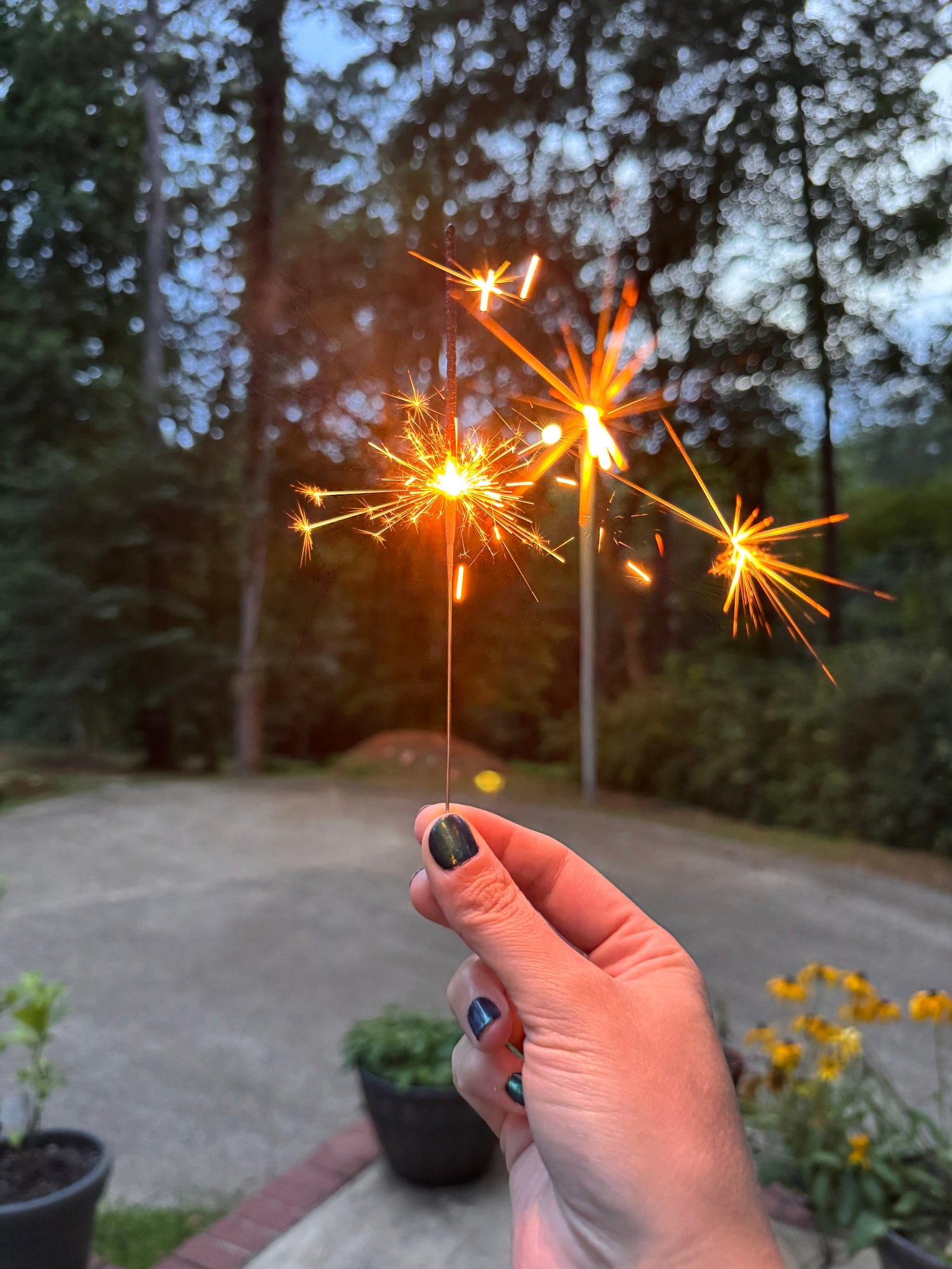 a glowing sparkler at dusk