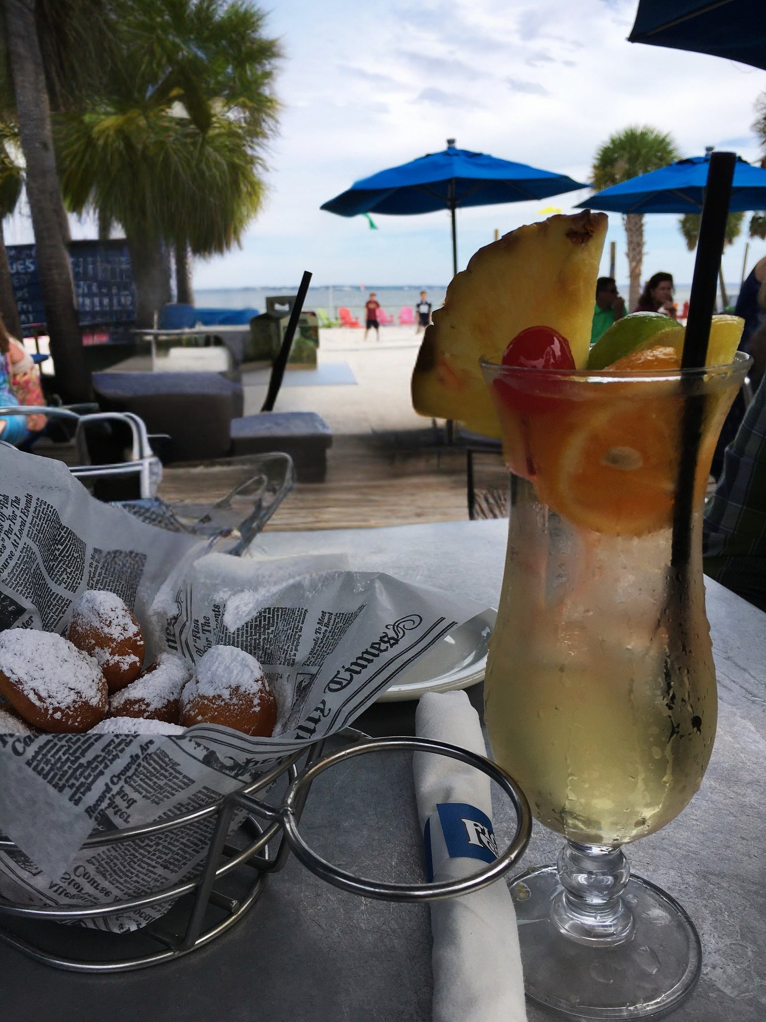 a fruity drink and beignets 