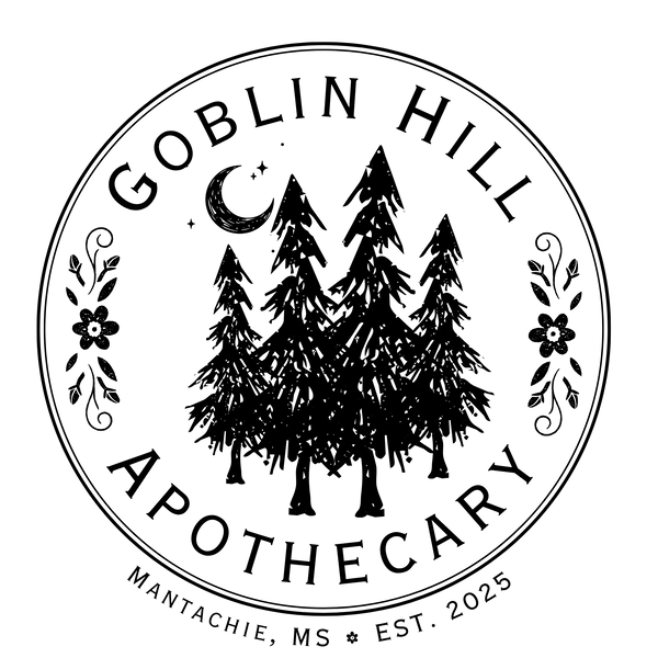 A circular black-and-white logo or label reading 'GOBLIN HILL APOTHECARY' with pine trees, a crescent moon, and small floral motifs. Smaller text at the bottom reads 'MANTACHIE, MS * EST.