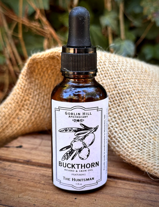 Close up of an amber dropper bottle of buckthorn beard oil