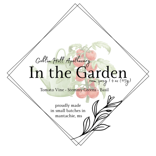 Label for Goblin Hill Apothecary's 'In the Garden' room spray with botanical design and text.
