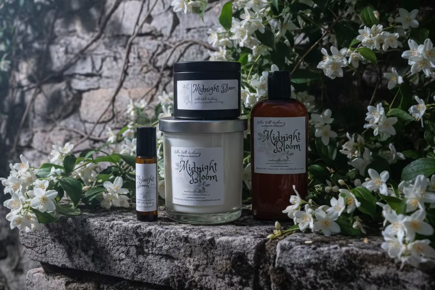 Collection of 'Midnight Bloom' products on a wooden surface with a store interior background.