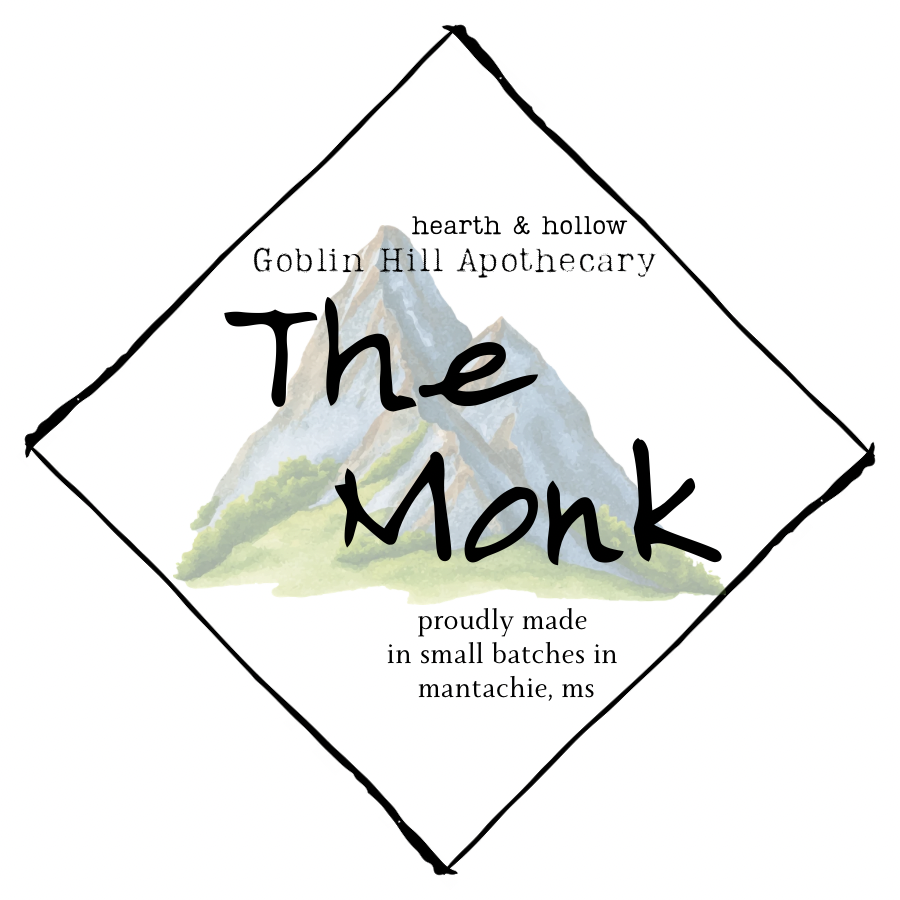 Logo for 'The Monk' from Goblin Hill Apothecary with a mountain illustration on a white background.