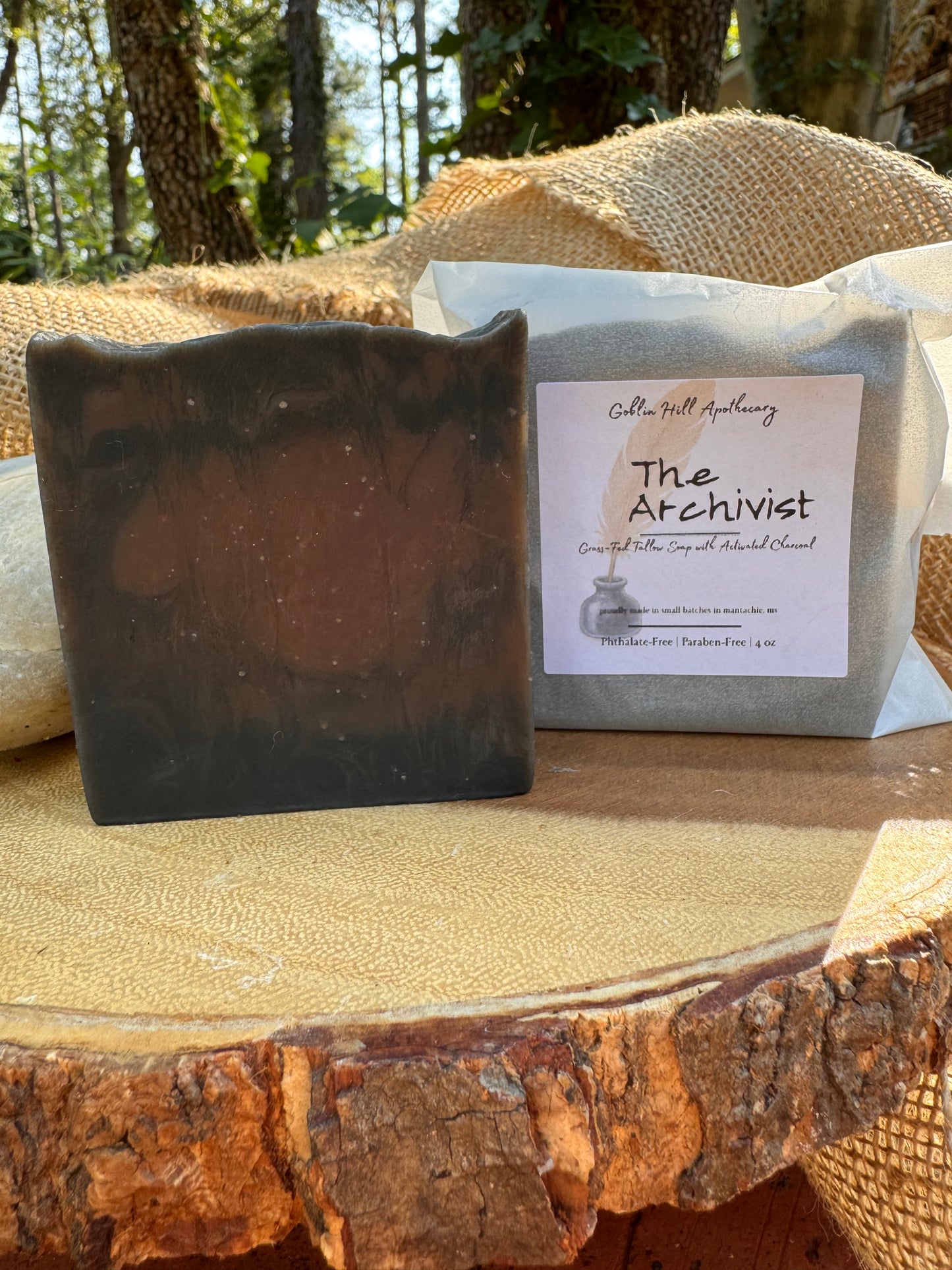 Bar of soap with 'The Archivist' label on a stone surface