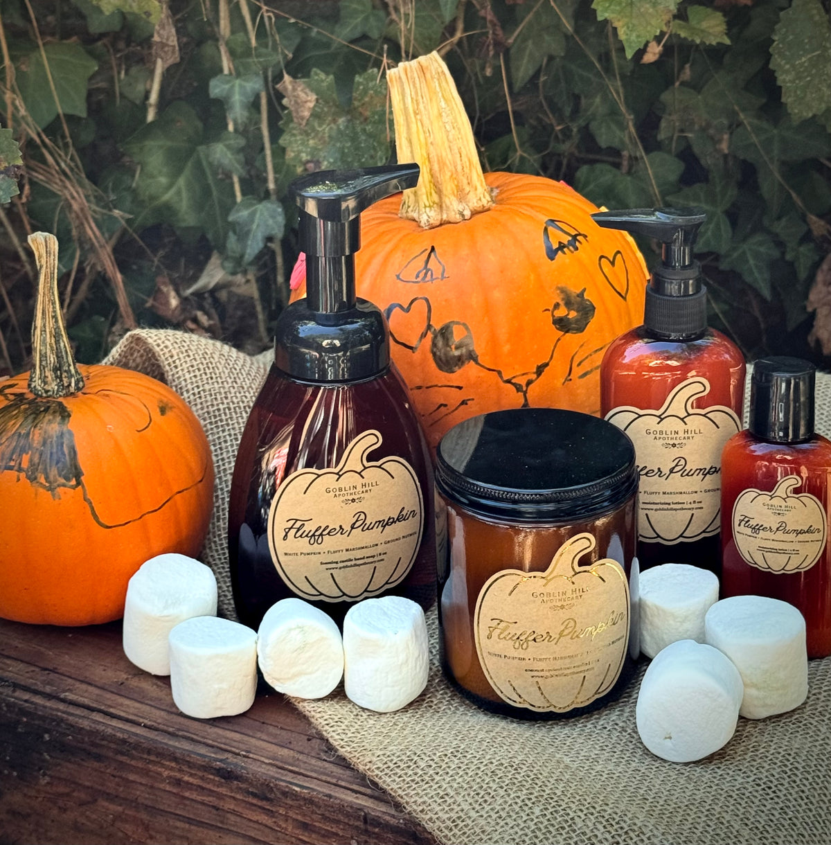amber bottles and jars surrounded by pumpkins and marshmallows