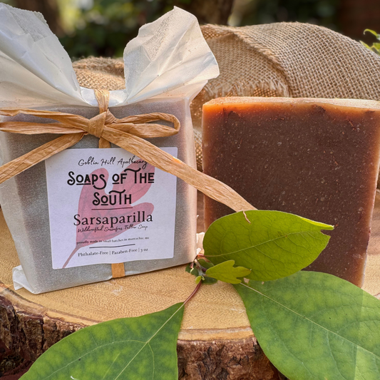 Bar of soap with a label on a wooden surface with leaves