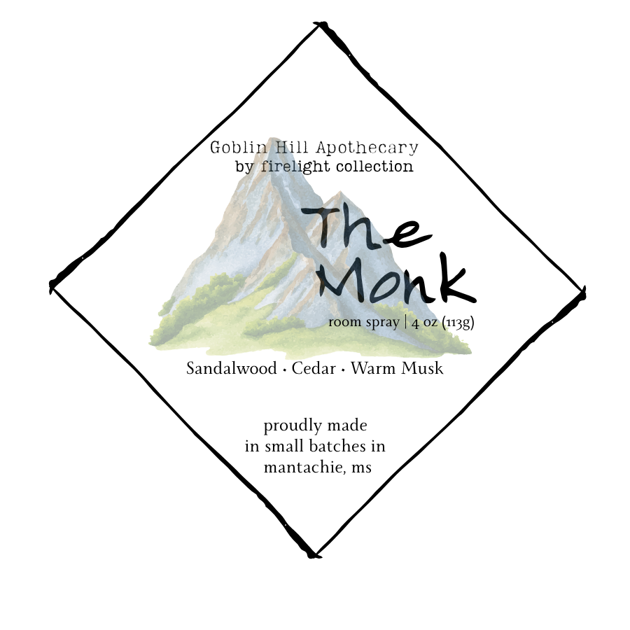 Label for 'The Monk' room spray by Goblin Hill Apothecary with mountain illustration.