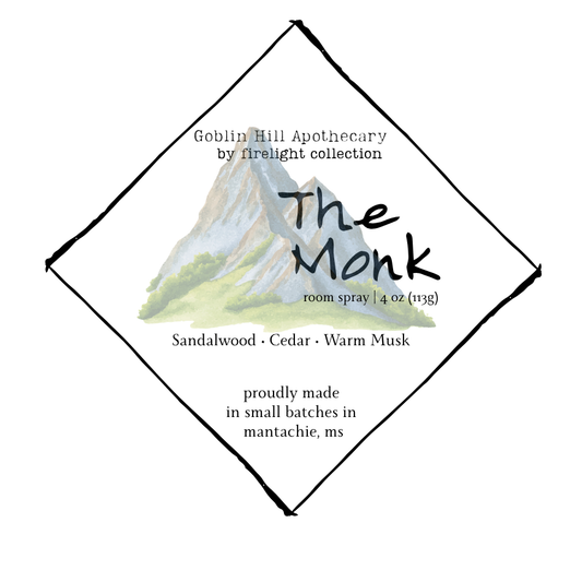 Label for 'The Monk' room spray by Goblin Hill Apothecary with mountain illustration.